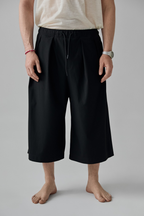 Men shorts made from Patternalism sewing pattern #0201 – front view, male model, black color
