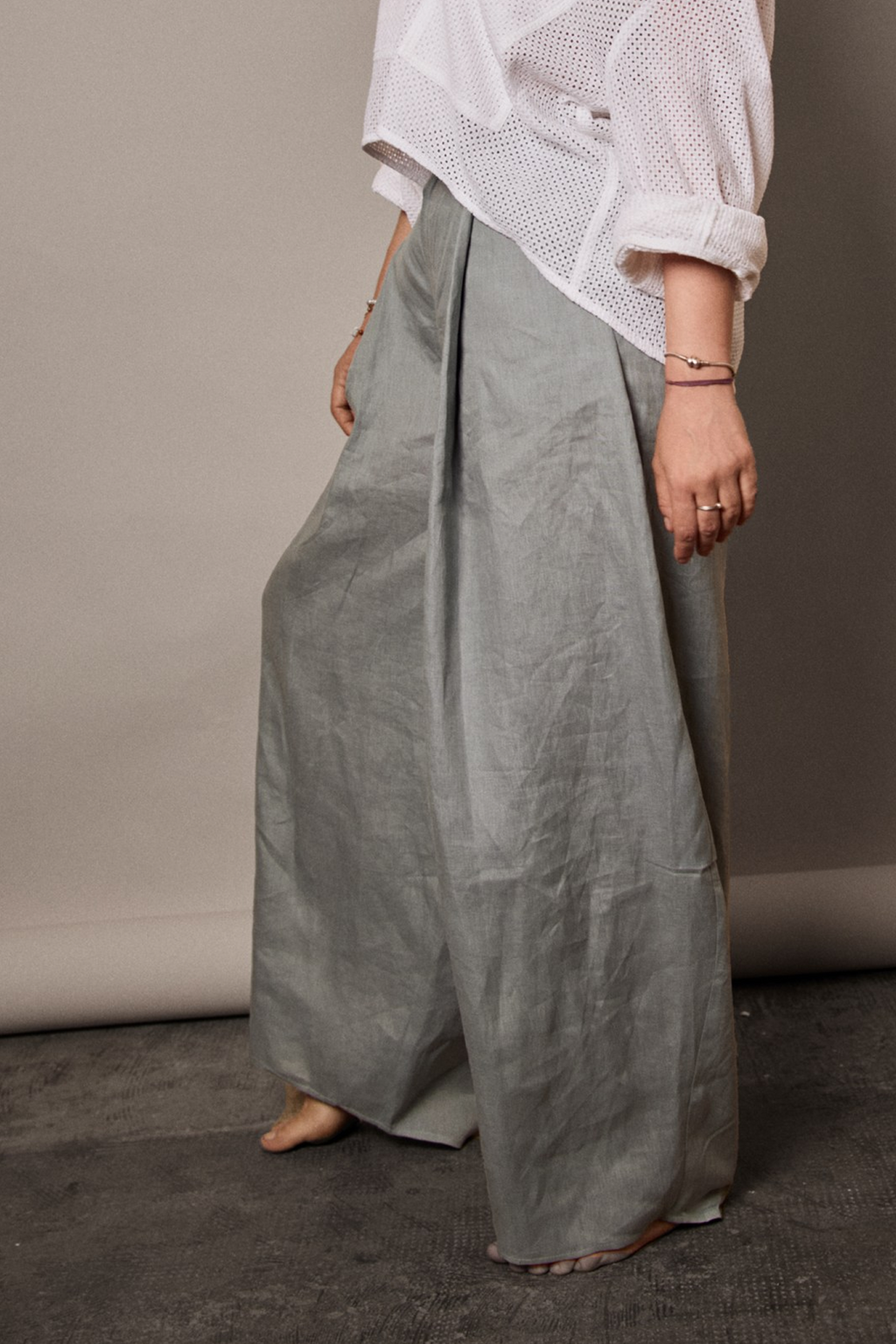 Side view of women pleated pants from Patternalism sewing pattern #0204