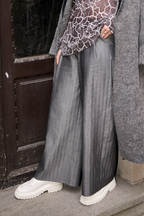 Frontside view of women pleated pants from Patternalism sewing pattern #0107